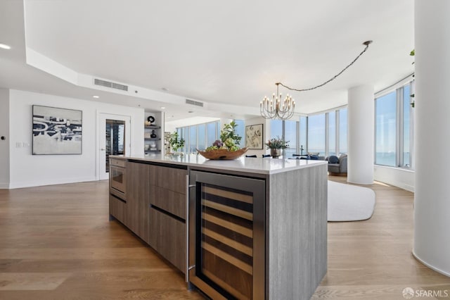 338 Main St Unit Ph36B, San Francisco, CA 94105 - kitchen featuring wine cooler, modern cabinets, open floor plan, a chandelier, and a spacious island