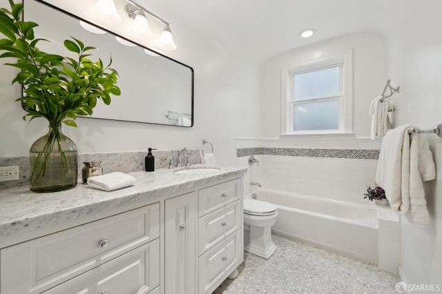 bathroom featuring vanity, toilet, a bathing tub, and tile patterned flooring