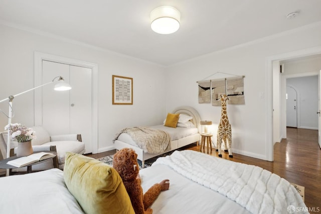 bedroom with crown molding and dark hardwood / wood-style floors