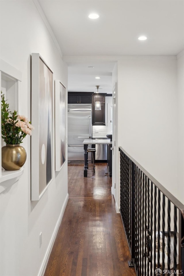 hall with dark hardwood / wood-style flooring and ornamental molding