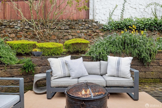 view of patio featuring an outdoor living space with a fire pit