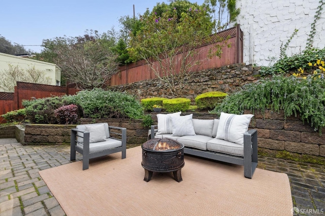 view of patio / terrace with an outdoor living space with a fire pit