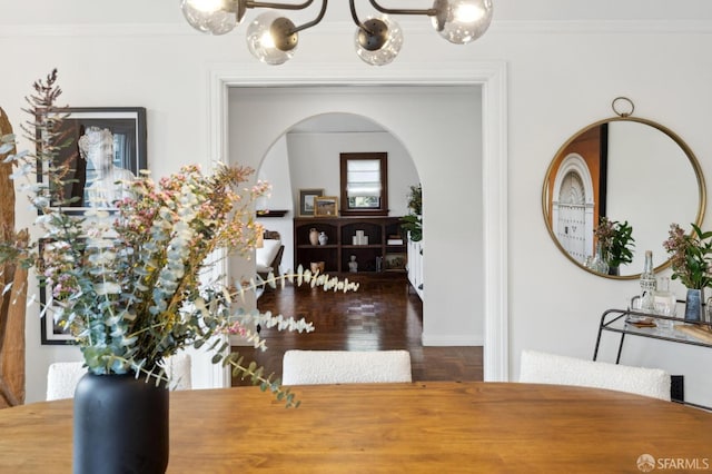 dining space with crown molding and dark wood-type flooring