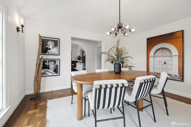 dining area with a notable chandelier, crown molding, vaulted ceiling, and dark parquet flooring