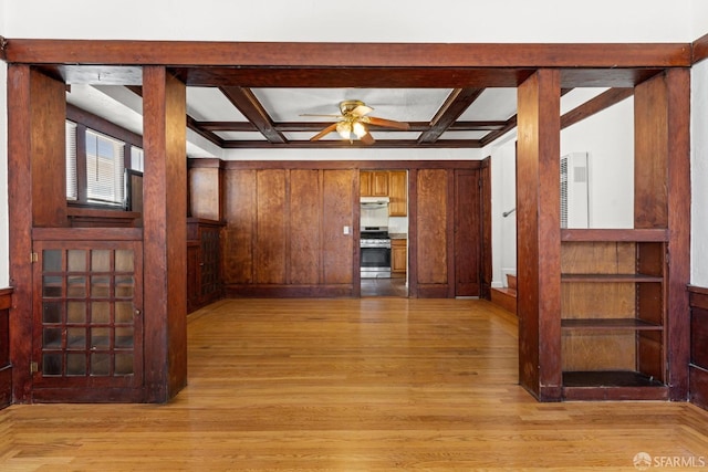 kitchen with ceiling fan, stainless steel range oven, light wood-type flooring, and coffered ceiling