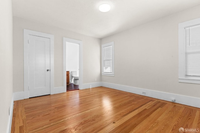 empty room featuring baseboards and wood finished floors