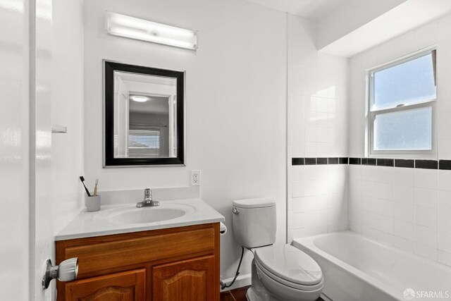 bathroom featuring bathtub / shower combination, vanity, and toilet