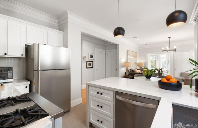 kitchen featuring light tile patterned floors, stainless steel appliances, light stone counters, white cabinets, and decorative light fixtures