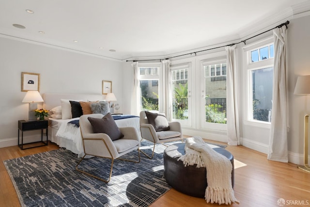 bedroom with multiple windows, ornamental molding, and light hardwood / wood-style floors