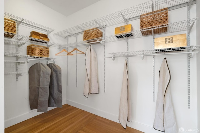 spacious closet featuring hardwood / wood-style flooring