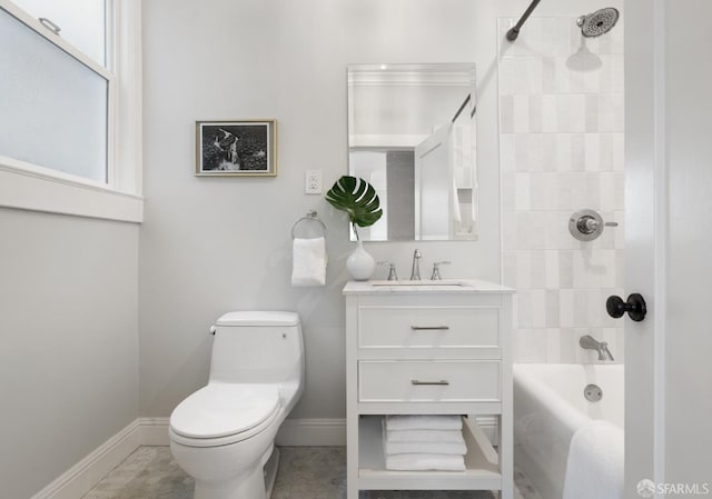 full bathroom featuring tiled shower / bath, vanity, and toilet