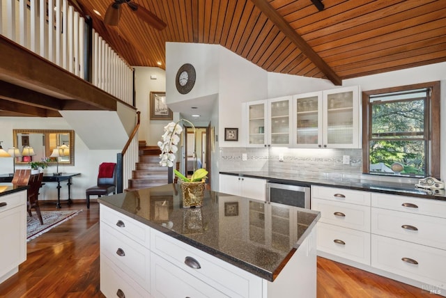 kitchen with dark wood finished floors, wood ceiling, beverage cooler, and tasteful backsplash