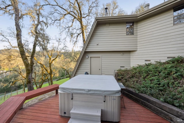 wooden deck with a hot tub