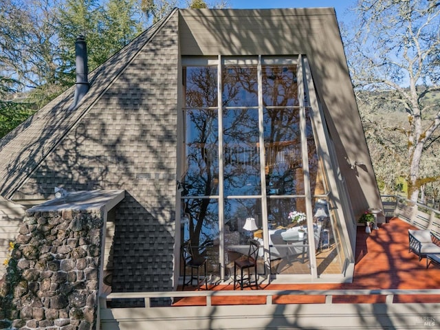 view of property exterior featuring roof with shingles