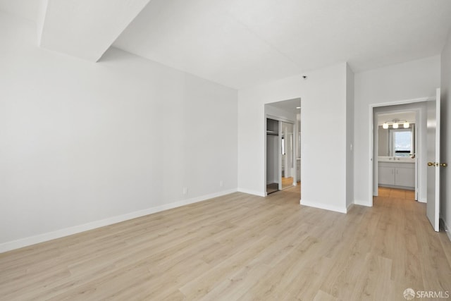 6363 Christie Ave Unit 1823, Emeryville, CA 94608 - unfurnished bedroom with light wood-style floors, baseboards, and a closet