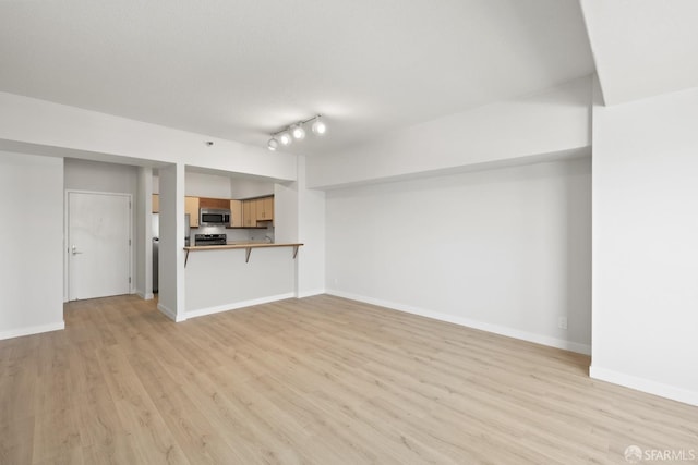 6363 Christie Ave Unit 1823, Emeryville, CA 94608 - unfurnished living room with baseboards and light wood finished floors