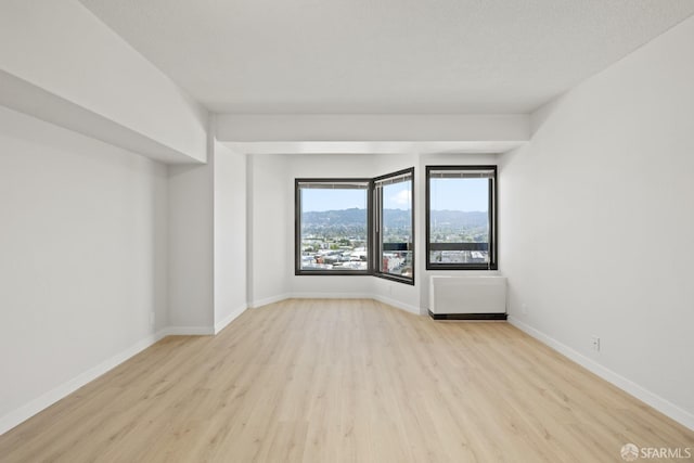 6363 Christie Ave Unit 1823, Emeryville, CA 94608 - unfurnished room with baseboards and wood finished floors