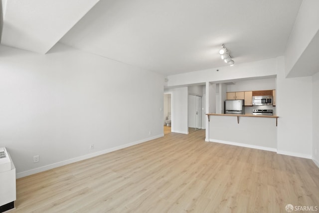 6363 Christie Ave Unit 1823, Emeryville, CA 94608 - unfurnished living room with light wood-type flooring and baseboards