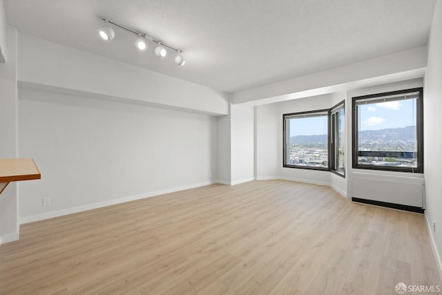 6363 Christie Ave Unit 1823, Emeryville, CA 94608 - spare room featuring baseboards and wood finished floors