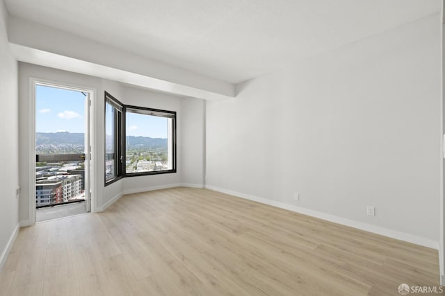 6363 Christie Ave Unit 1823, Emeryville, CA 94608 - unfurnished room featuring baseboards and light wood-style flooring