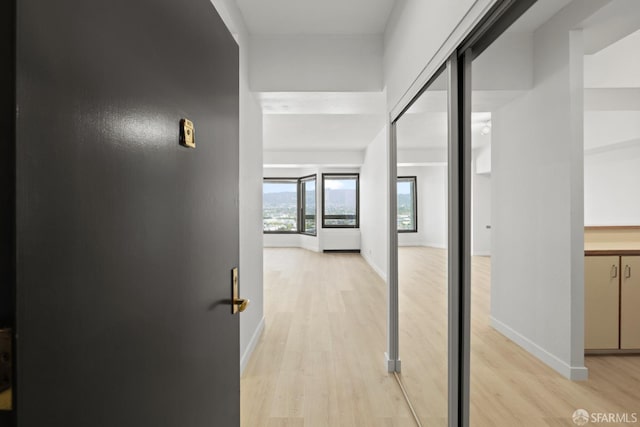 6363 Christie Ave Unit 1823, Emeryville, CA 94608 - hallway with baseboards and light wood-style flooring