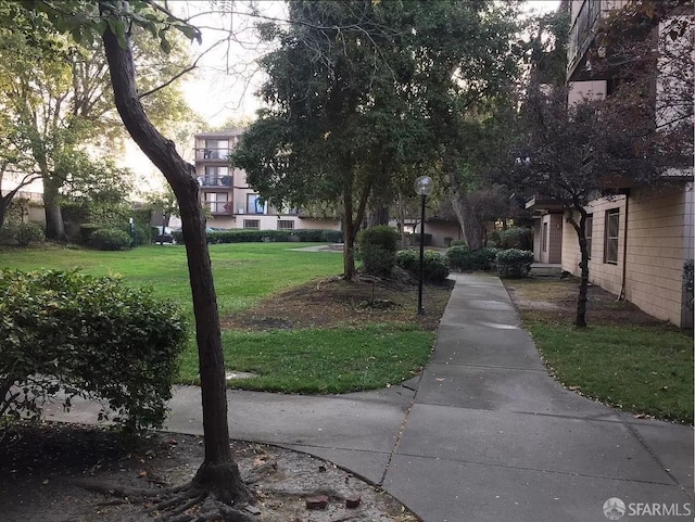 view of property's community with a lawn