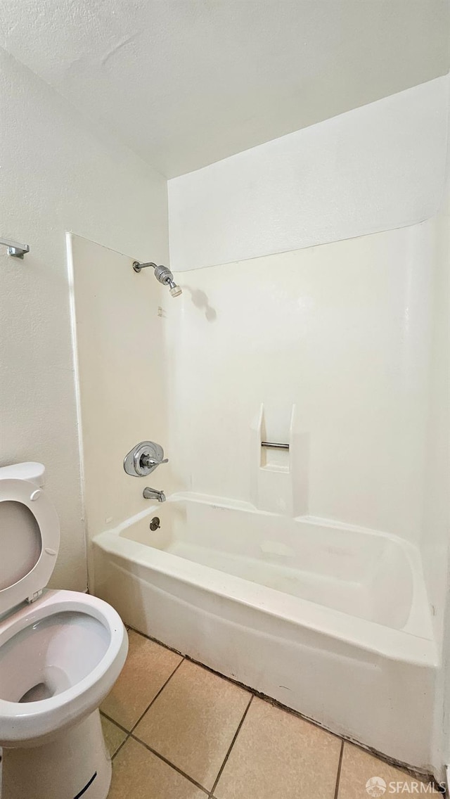 bathroom with tub / shower combination, tile patterned floors, and toilet