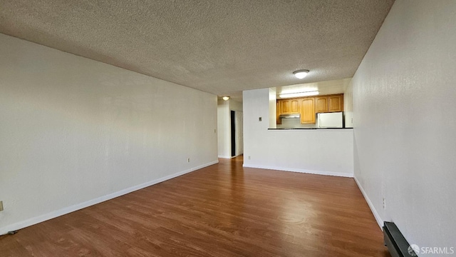 unfurnished living room featuring dark hardwood / wood-style floors and a textured ceiling