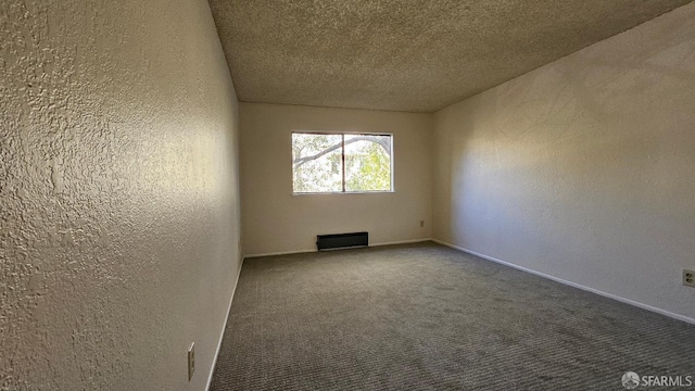 carpeted spare room featuring a textured ceiling