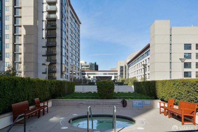 view of swimming pool featuring a patio area and a community hot tub