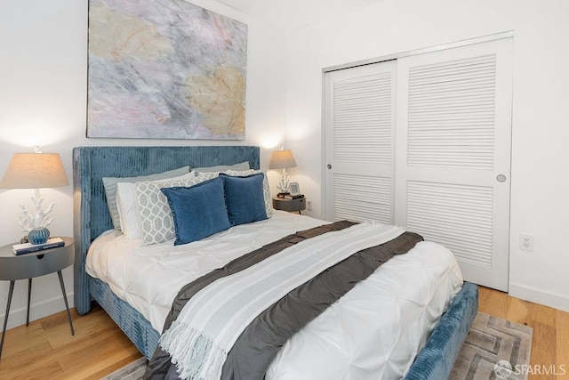 bedroom featuring wood-type flooring and a closet