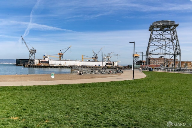 view of home's community featuring a yard and a water view