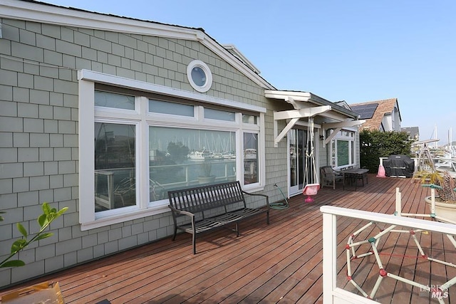 wooden deck with a grill