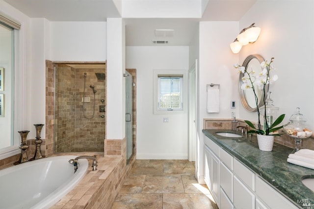 bathroom with a sink, visible vents, a shower stall, a bath, and double vanity