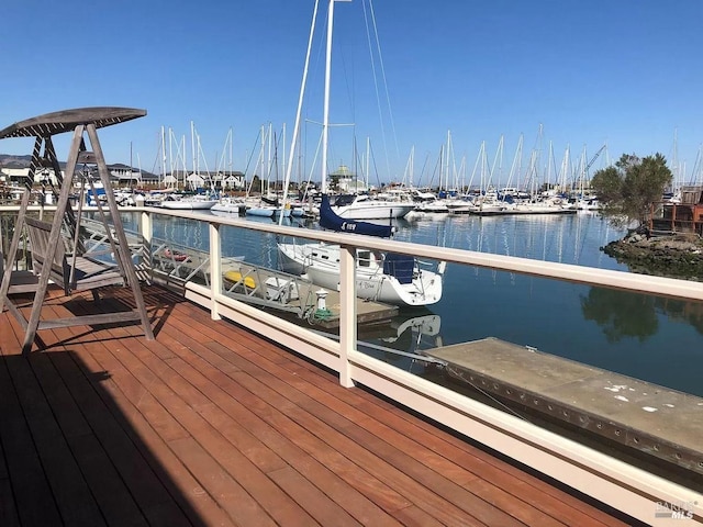 view of dock featuring a water view and a balcony