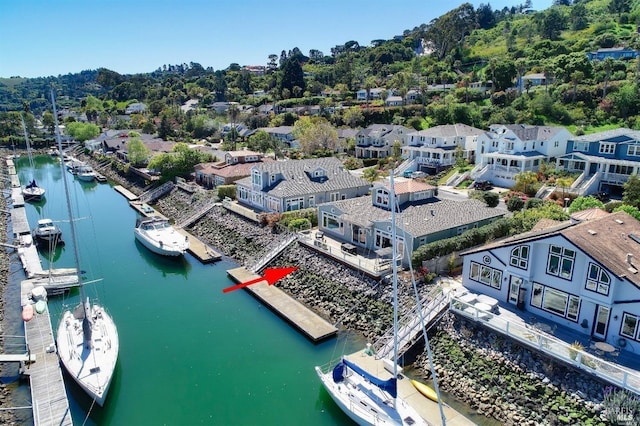 drone / aerial view featuring a water view and a residential view