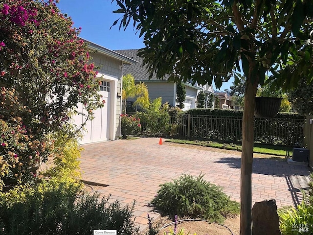 view of patio featuring a garage and fence