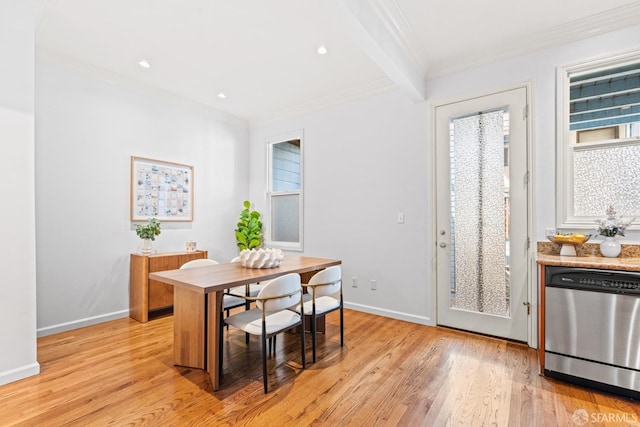 dining room with ornamental molding, baseboards, light wood-type flooring, and a healthy amount of sunlight