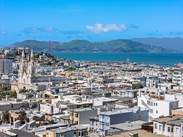 property's view of city featuring a water and mountain view