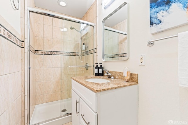 full bathroom with vanity and a stall shower