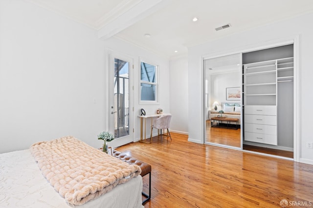 bedroom featuring light wood-type flooring, a closet, ornamental molding, recessed lighting, and baseboards