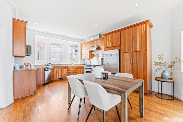 dining room featuring recessed lighting, light wood-type flooring, and ornamental molding