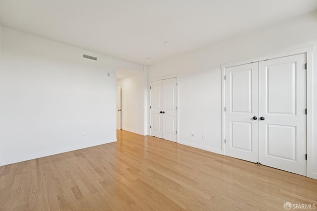 104 Diamond Cove Ter, San Francisco, CA 94134 - unfurnished bedroom featuring multiple closets and light wood-style floors