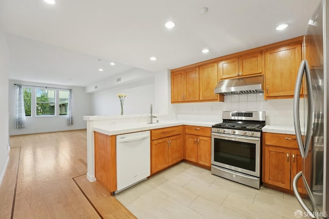 104 Diamond Cove Ter, San Francisco, CA 94134 - kitchen featuring appliances with stainless steel finishes, under cabinet range hood, open floor plan, recessed lighting, and a peninsula