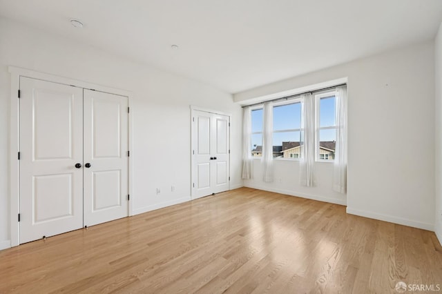 104 Diamond Cove Ter, San Francisco, CA 94134 - unfurnished bedroom with multiple closets and light wood finished floors