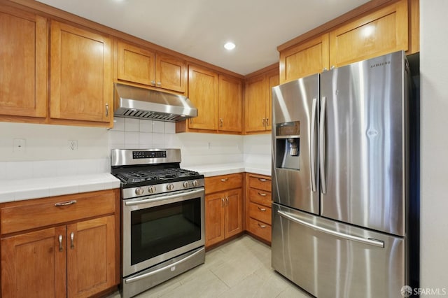 104 Diamond Cove Ter, San Francisco, CA 94134 - kitchen featuring appliances with stainless steel finishes, under cabinet range hood, tile countertops, tasteful backsplash, and recessed lighting