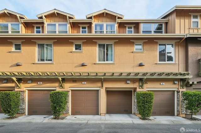 104 Diamond Cove Ter, San Francisco, CA 94134 - back of property featuring board and batten siding, a garage, driveway, and stucco siding