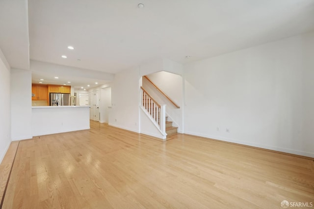 104 Diamond Cove Ter, San Francisco, CA 94134 - unfurnished living room with light wood finished floors, stairs, and recessed lighting