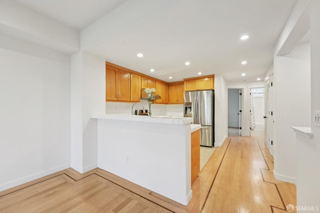 104 Diamond Cove Ter, San Francisco, CA 94134 - kitchen with stainless steel fridge with ice dispenser, light wood-type flooring, a peninsula, tile countertops, and recessed lighting