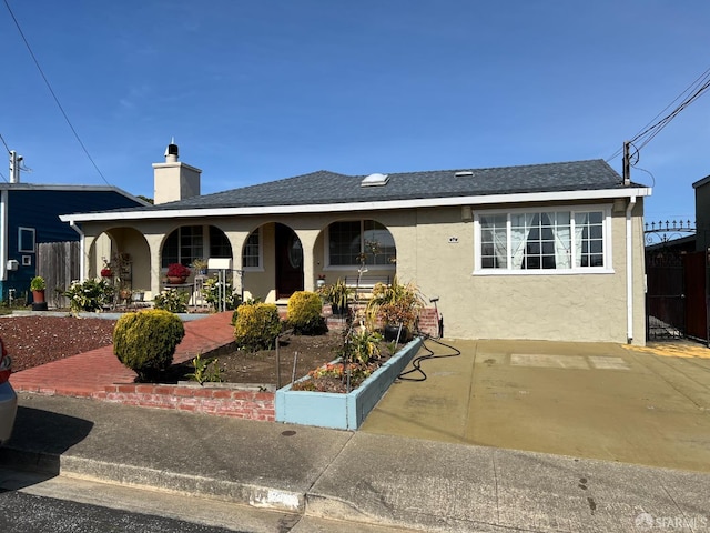 ranch-style house with a chimney, stucco siding, a porch, and fence